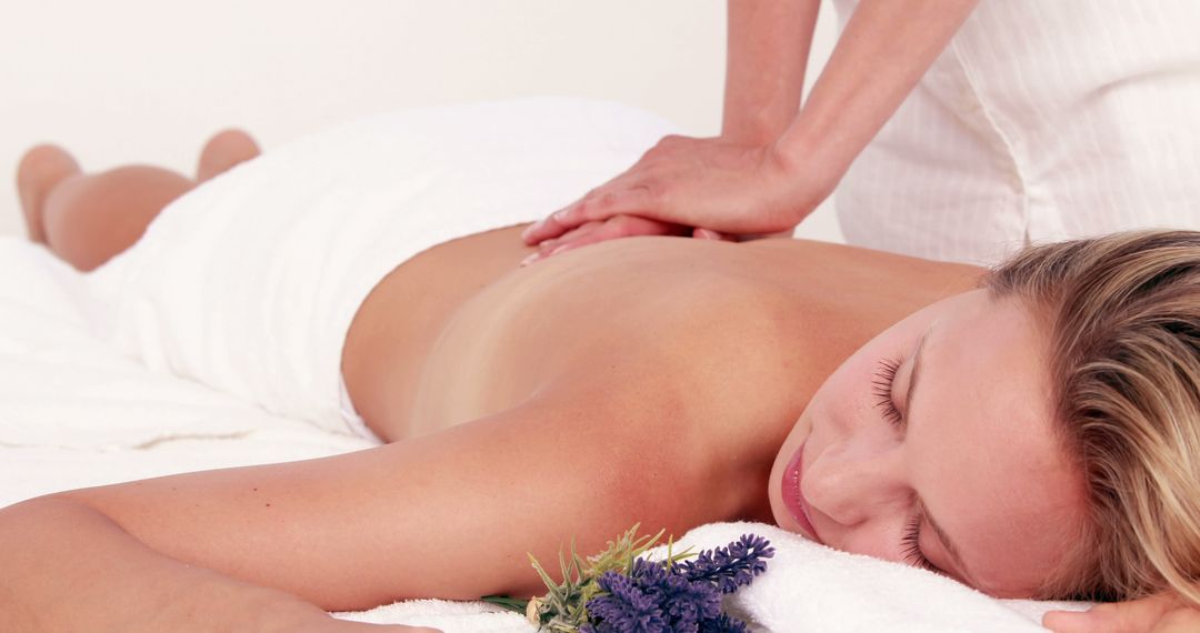 A Caucasian woman enjoys a relaxing massage in a serene spa environment, with copy space - Free Images, Stock Photos and Pictures on Pikwizard.com