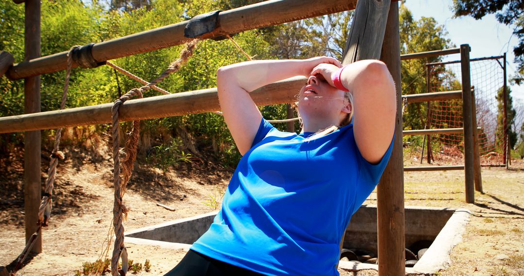 Exhausted Woman Resting During Outdoor Obstacle Course - Free Images, Stock Photos and Pictures on Pikwizard.com