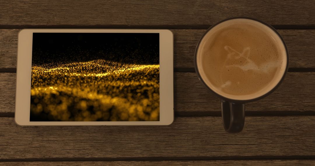 Smartphone with Abstract Gold Light Trails Display and Coffee Mug