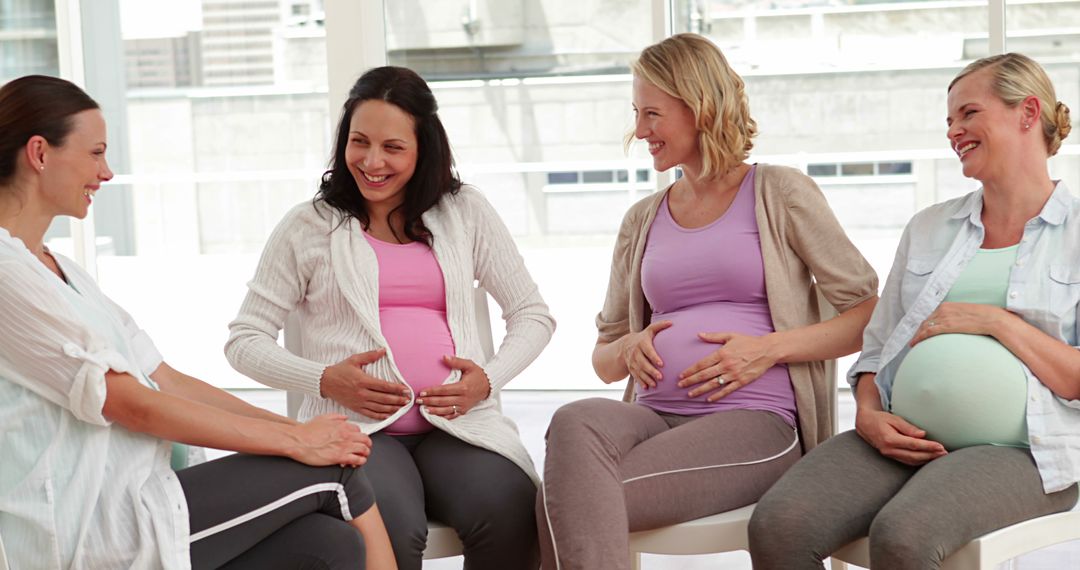 Pregnant Women Sitting Together Smiling in Group - Free Images, Stock Photos and Pictures on Pikwizard.com