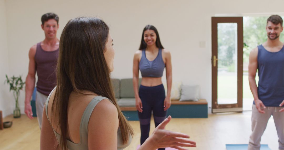 Yoga Instructor Leading Multicultural Class in Modern Studio