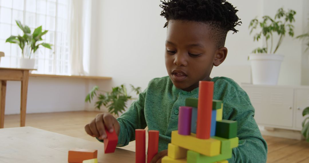 Young Boy Building Colorful Wooden Block Tower at Home - Free Images, Stock Photos and Pictures on Pikwizard.com