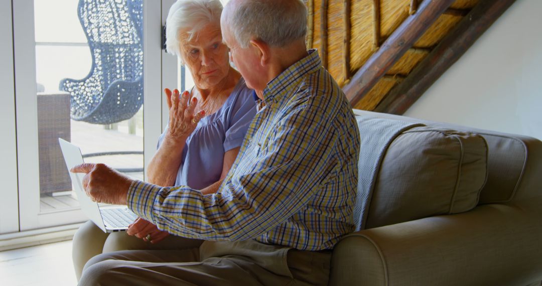 Senior Couple Engaged in Online Activity Using Laptop