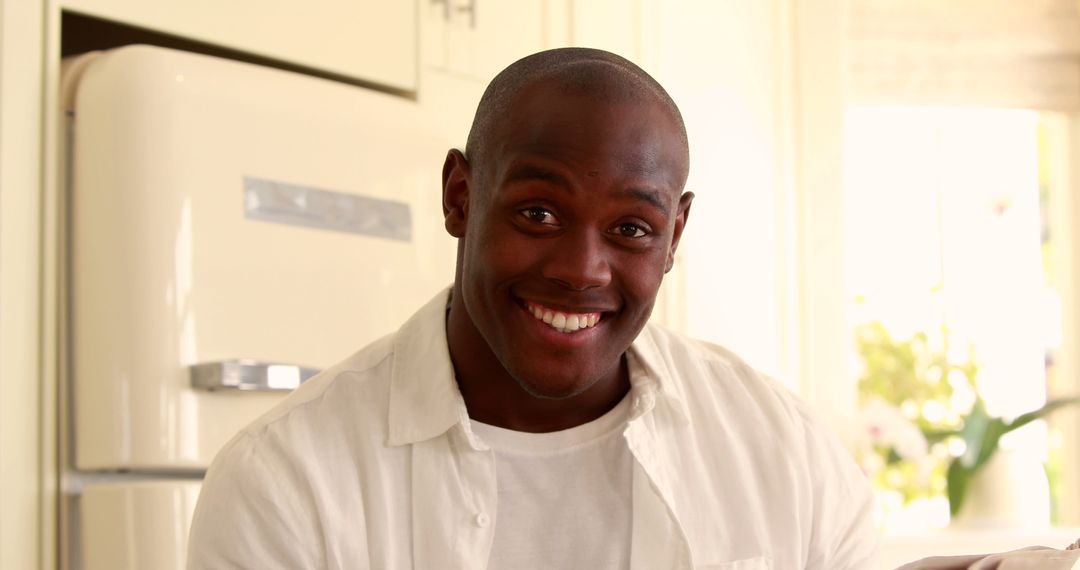 Smiling Man Enjoying Morning Coffee in Home Kitchen