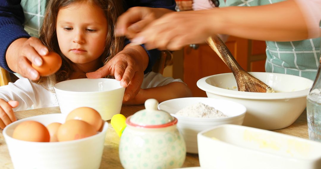 Child Learning to Bake with Parental Guidance in Kitchen