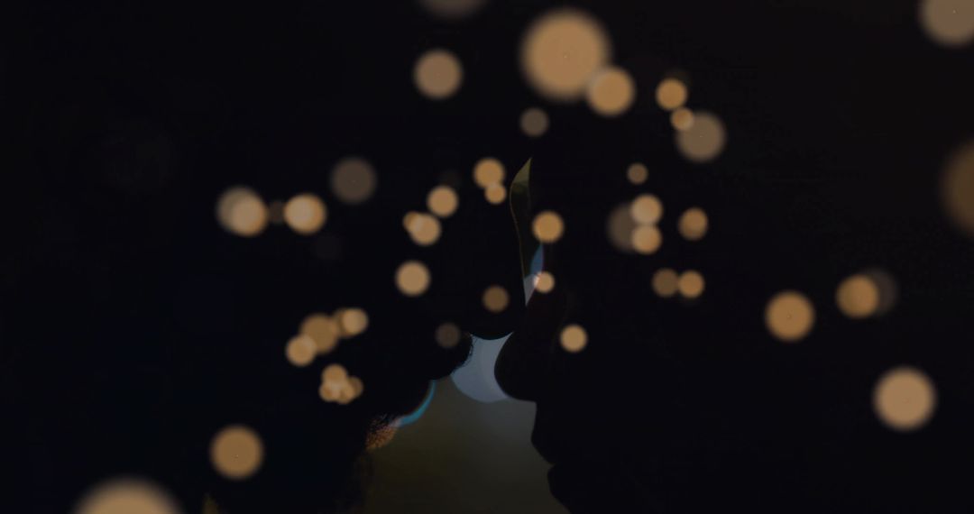 Silhouette of Couple in Intimate Setting with String Lights