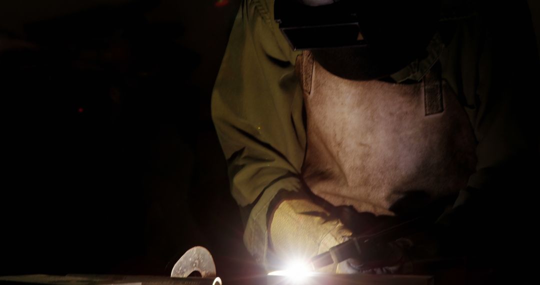 Meticulous Work of Professional Welder in Dimly Lit Workshop - Free Images, Stock Photos and Pictures on Pikwizard.com