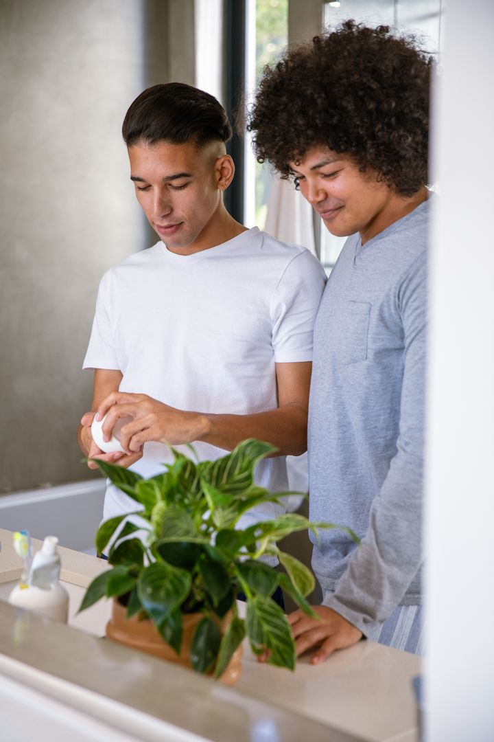 Diverse Friends Sharing Grooming Routine in Modern Bathroom