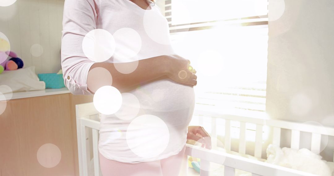 Pregnant Woman Gently Cradling Belly in Sunlit Nursery - Free Images, Stock Photos and Pictures on Pikwizard.com