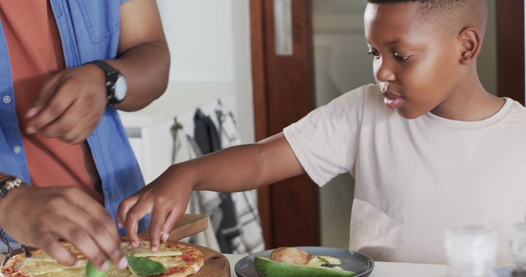 Father and Child Bonding While Preparing Homemade Pizza in Kitchen