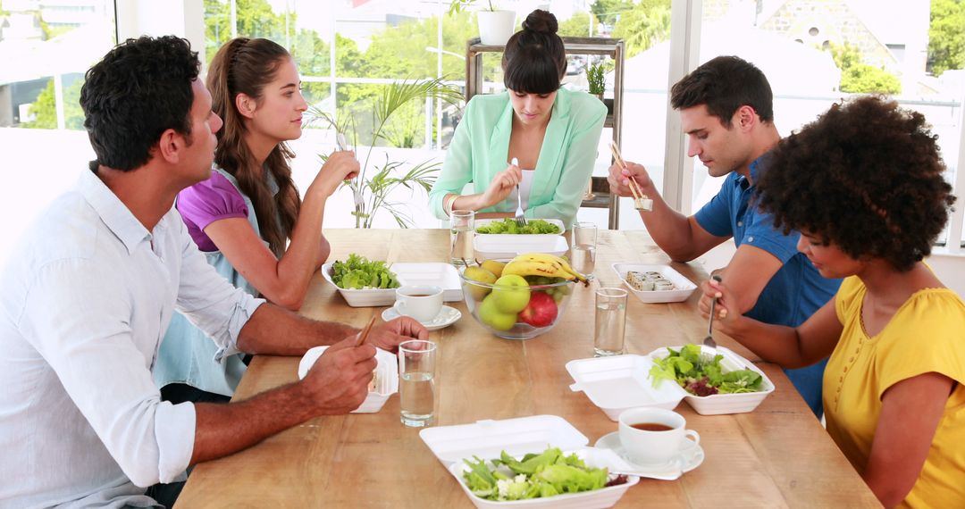 Diverse Group Sharing Healthy Meal Around Communal Table