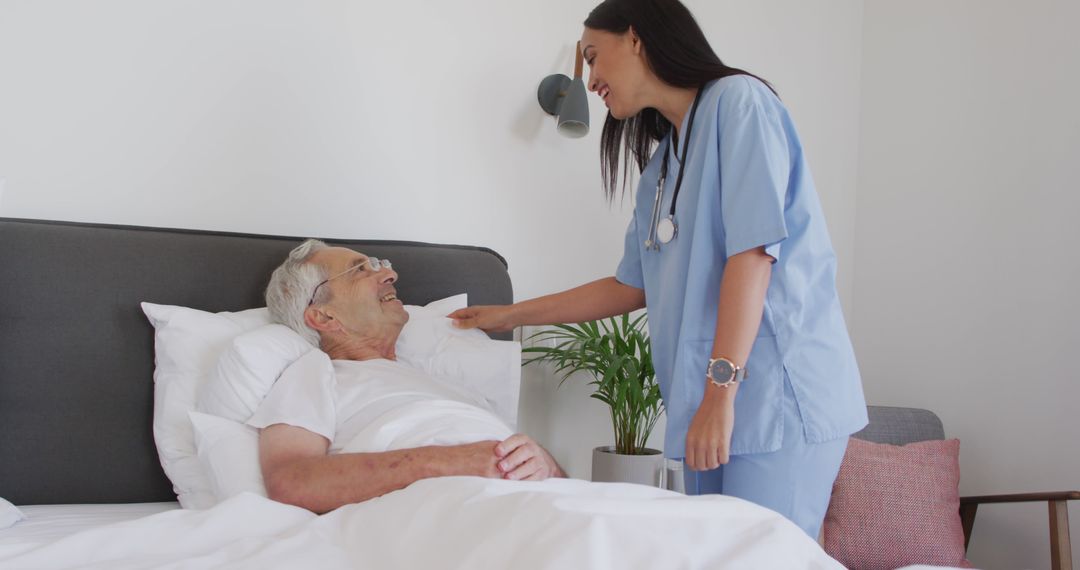 Nurse Comforting Elderly Man in Hospital Bed - Free Images, Stock Photos and Pictures on Pikwizard.com