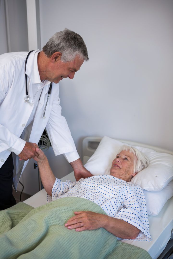 Doctor examining senior patient in ward - Free Images, Stock Photos and Pictures on Pikwizard.com