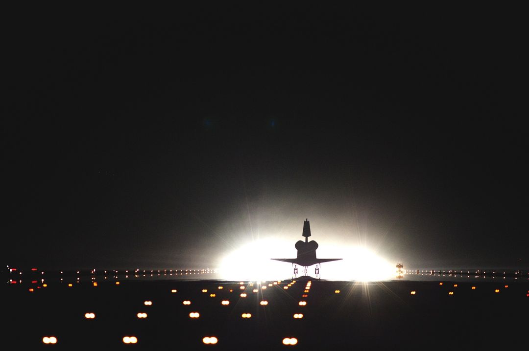 Space Shuttle Illuminated on Runway at Night During Landing - Free Images, Stock Photos and Pictures on Pikwizard.com