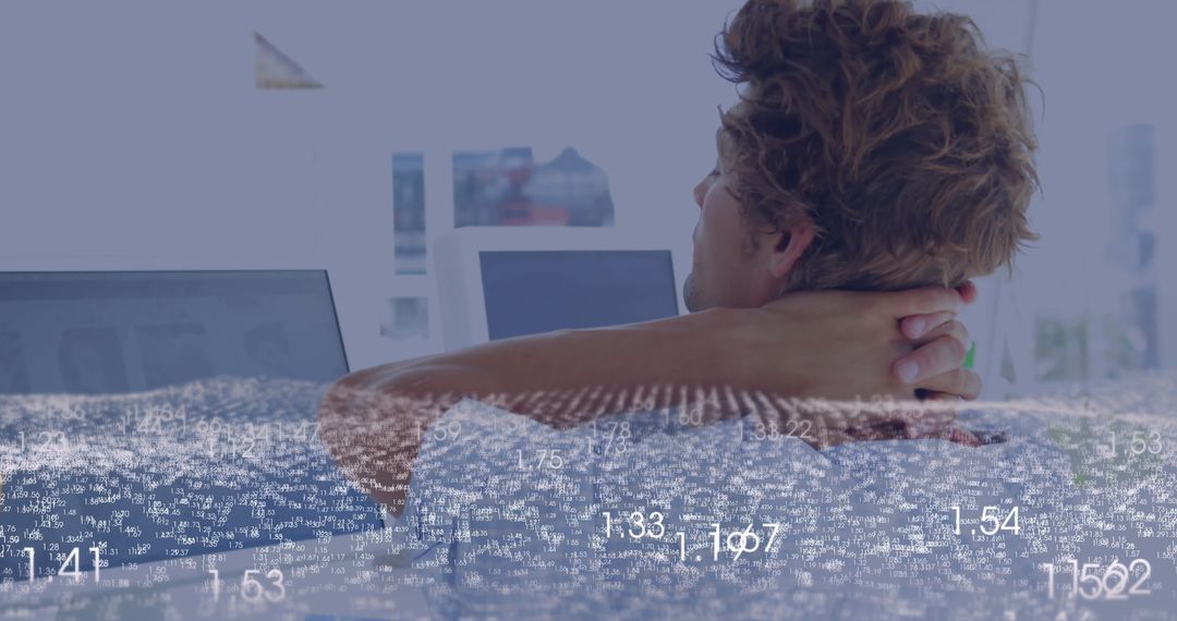 Businessman Analyzing Data on Screens in Contemporary Office