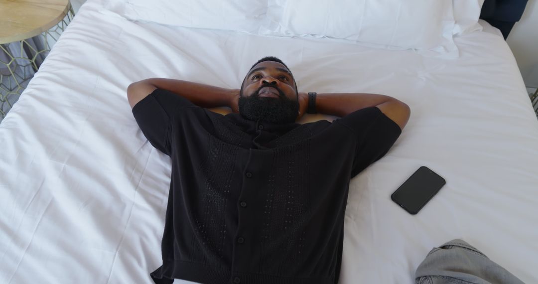 Man Relaxing on Bed Contemplating Possibilities