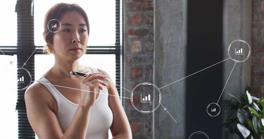 Businesswoman Analyzing Data with Virtual Interface in Office