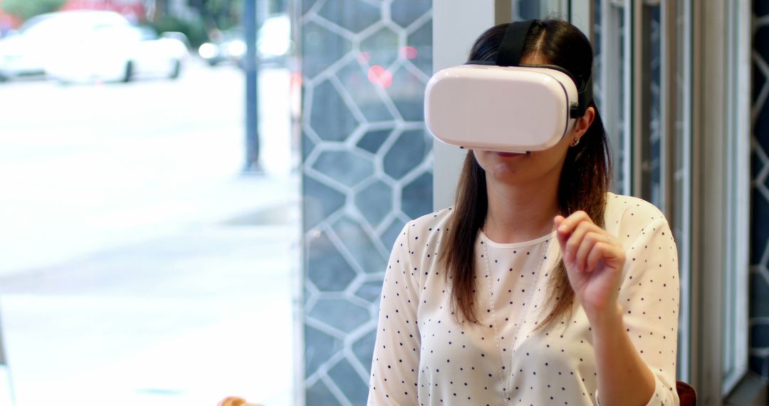 Young woman experiencing virtual reality with VR headset indoors - Free Images, Stock Photos and Pictures on Pikwizard.com