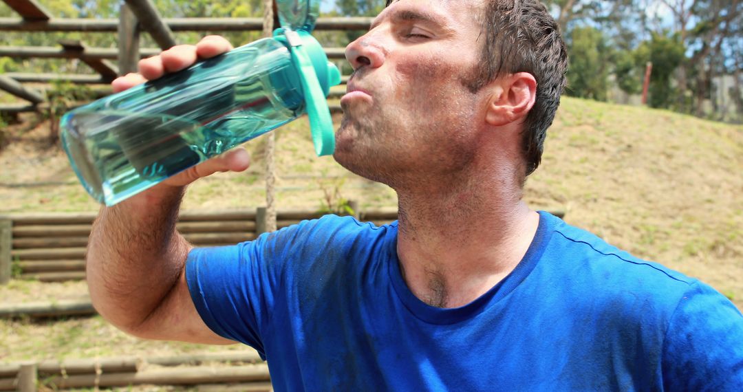 Man Drinking Water During Outdoor Fitness Training - Free Images, Stock Photos and Pictures on Pikwizard.com