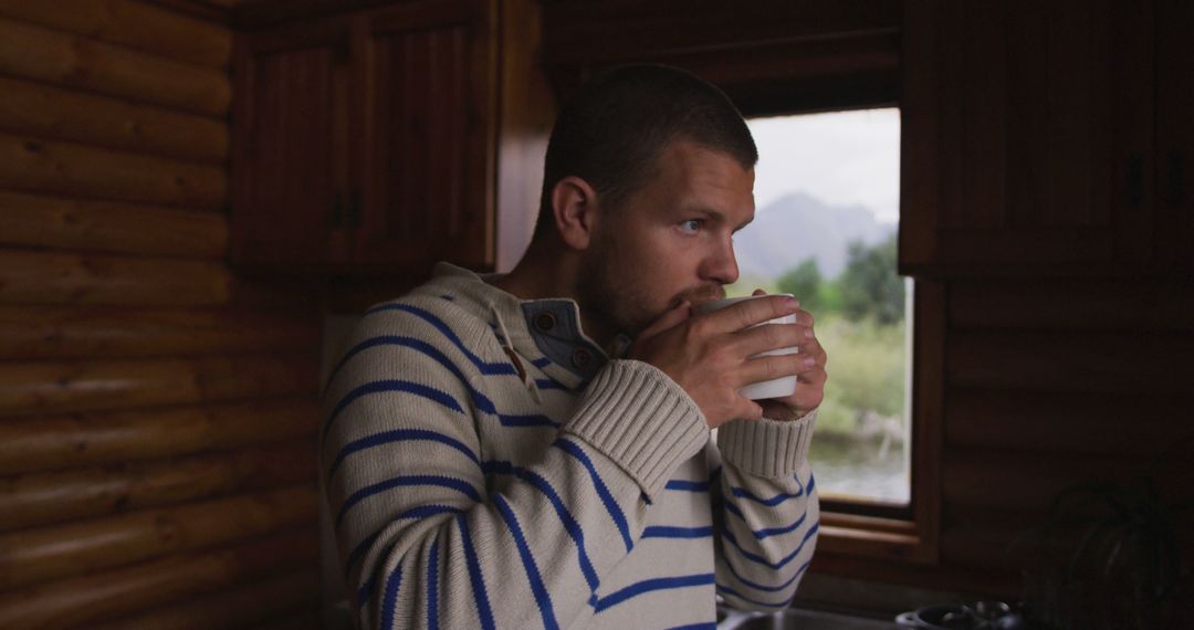 Man Drinking Coffee Inside Wooden Cabin - Free Images, Stock Photos and Pictures on Pikwizard.com