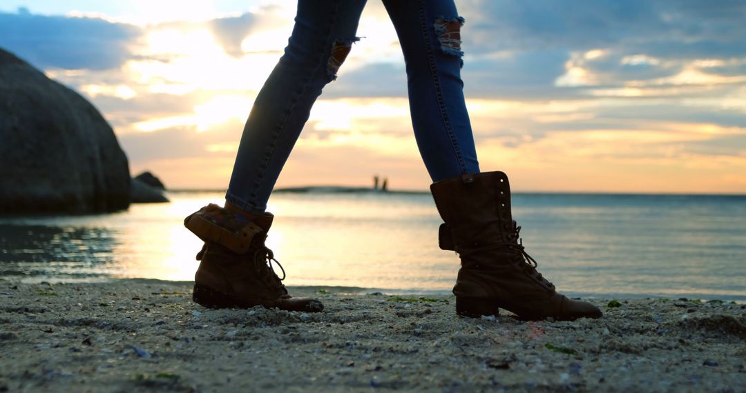 Person Walking on Beach at Sunset with Stylish Boots - Free Images, Stock Photos and Pictures on Pikwizard.com