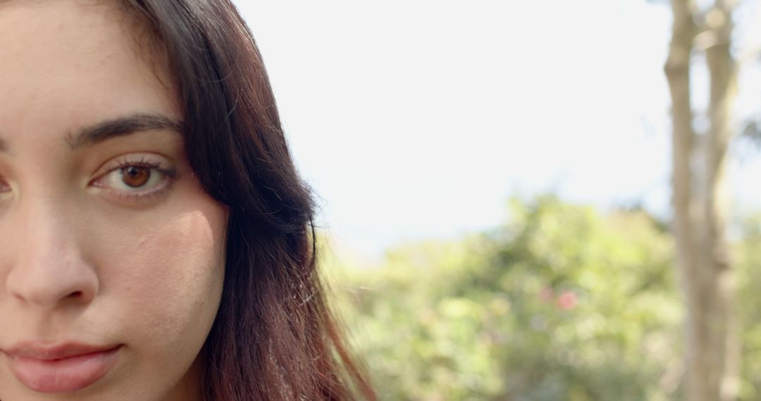 Serene Woman in Garden with Soft Sunlight on Profile