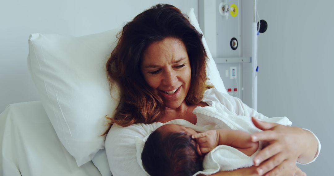 Mother Holding Newborn Baby in Hospital Bed, Smiling with Love - Free Images, Stock Photos and Pictures on Pikwizard.com