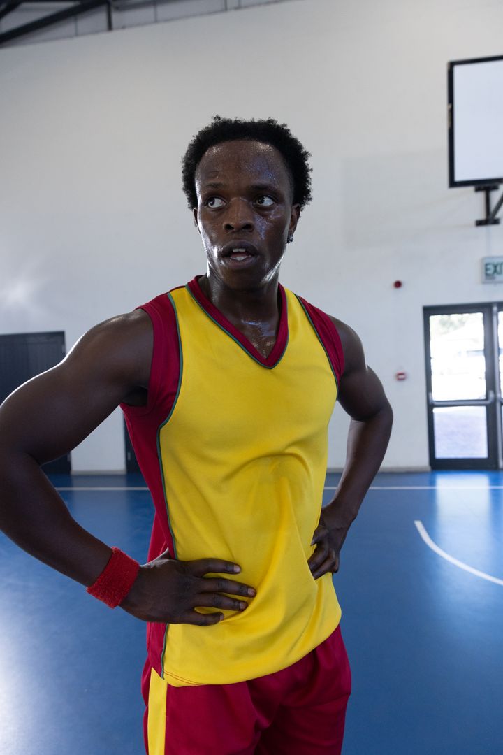 Athlete in Vibrant Uniform Resting After Intense Game