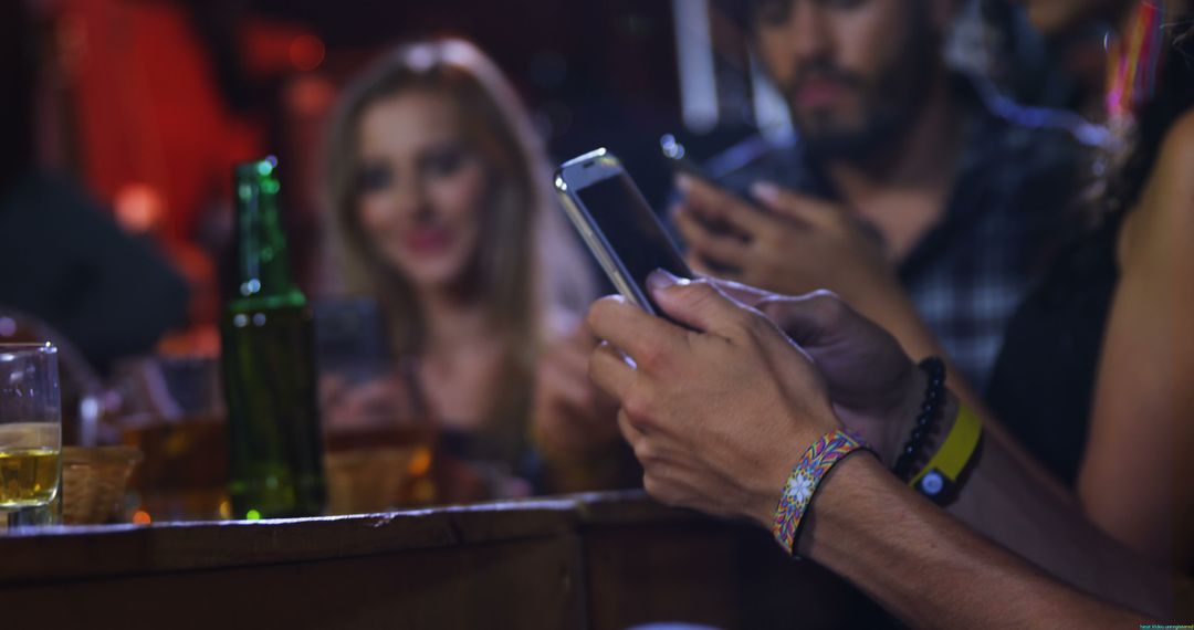 Modern Nightlife Socializing with Smartphones at Bar