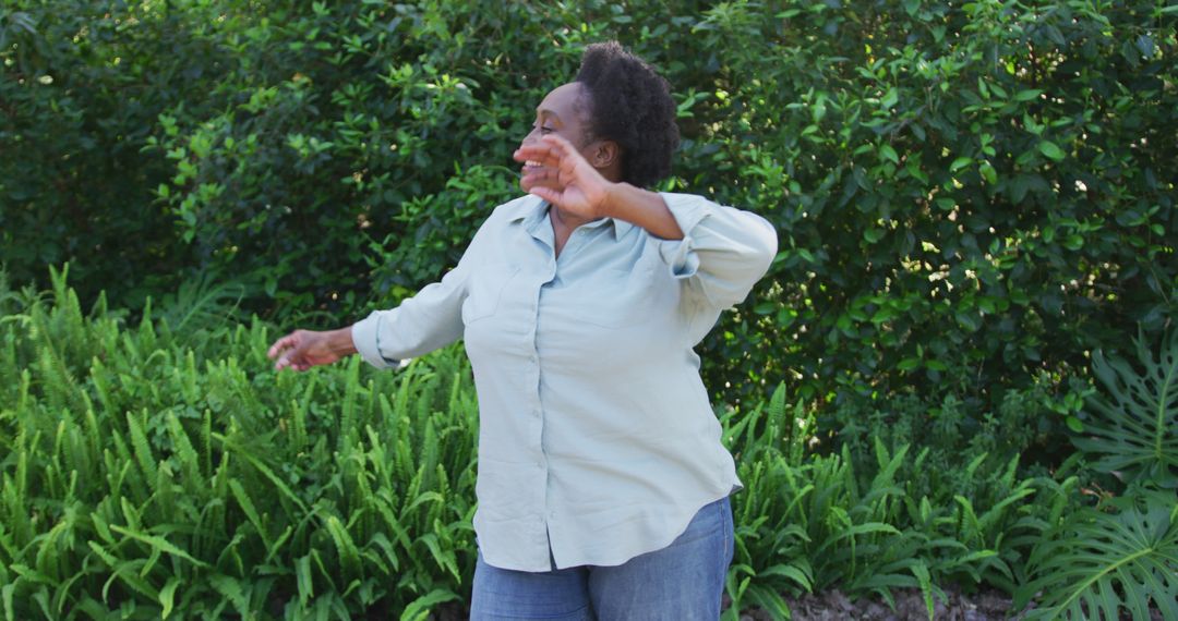 African american senior woman dancing in the garden - Free Images, Stock Photos and Pictures on Pikwizard.com