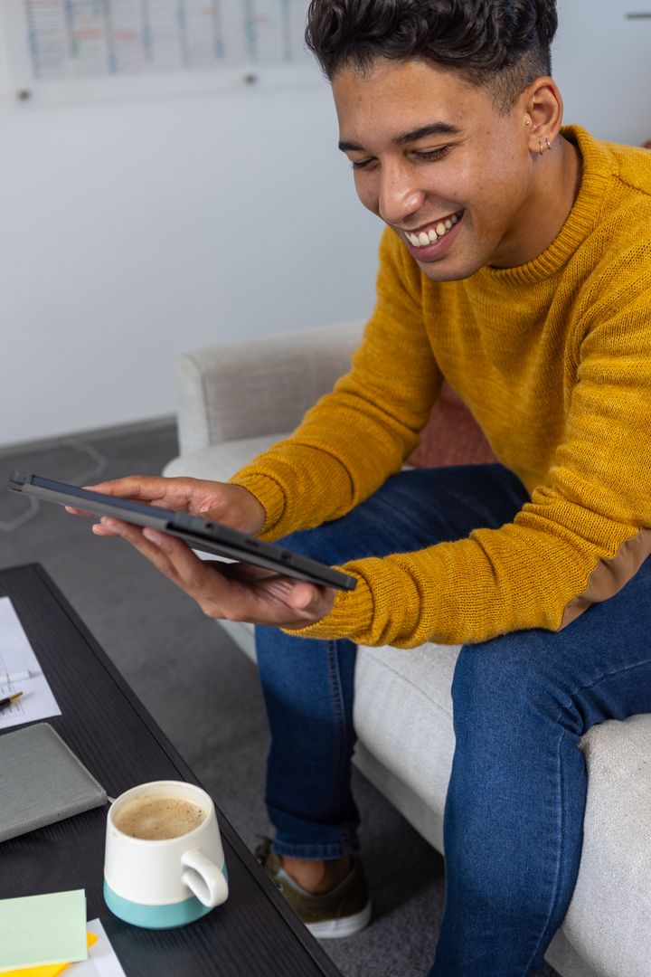Smiling Man Using Tablet in Cozy Modern Workspace
