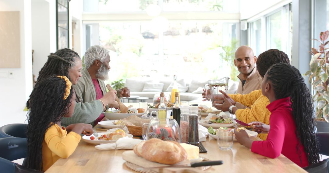 Multigenerational family sharing meal and passing pitcher around dining table in modern home