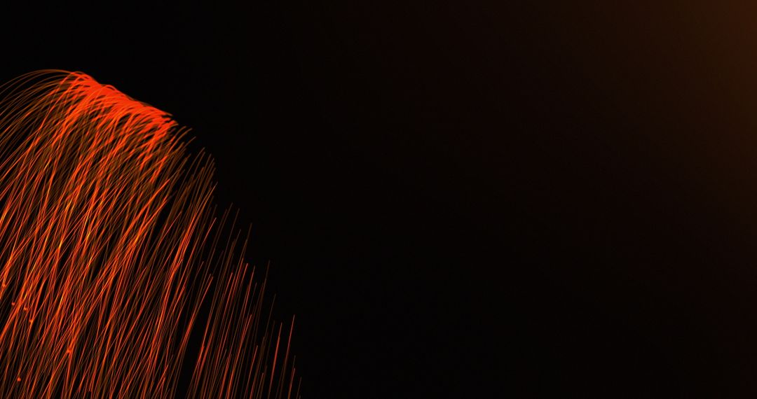 Hypnotic Motion of Flowing Orange Light Trails on Dark Background