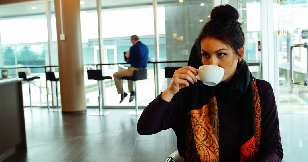 Woman Drinking Coffee in Modern Cafe - Free Images, Stock Photos and Pictures on Pikwizard.com