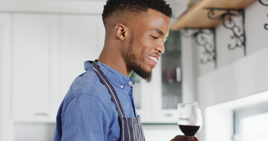 Smiling Man in Kitchen Enjoying Glass of Red Wine - Free Images, Stock Photos and Pictures on Pikwizard.com