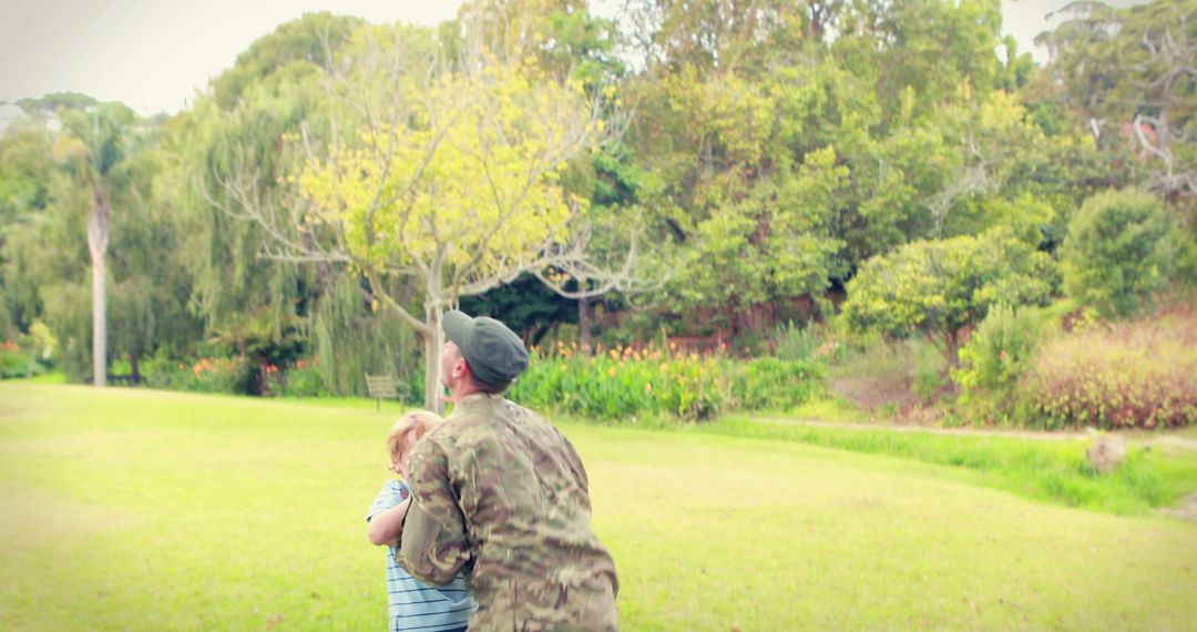 Soldier Embracing Child in Nature Setting - Free Images, Stock Photos and Pictures on Pikwizard.com