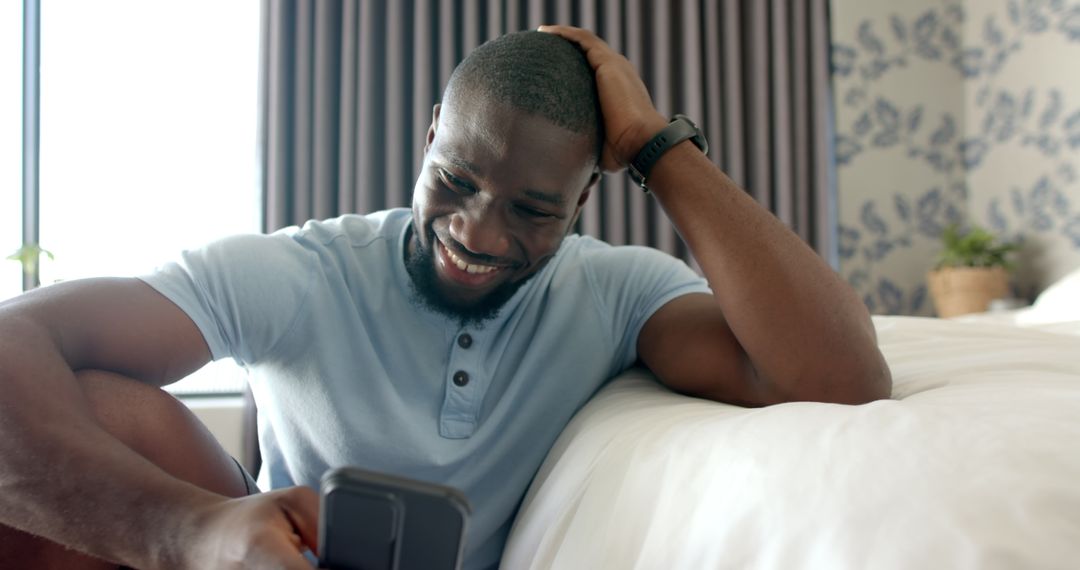 Smiling Young Man Relaxing Home Checking Smartphone