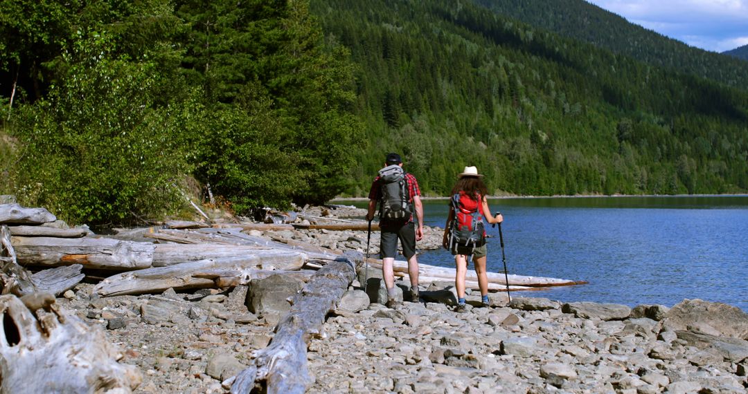 Couple Hiking Along Scenic Lakeside Trail Exploring Wilderness