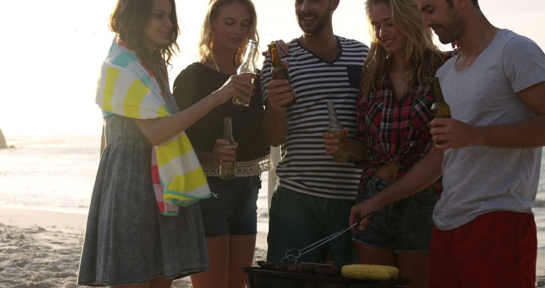 Group of Friends Enjoying BBQ on Beach at Sunset - Free Images, Stock Photos and Pictures on Pikwizard.com