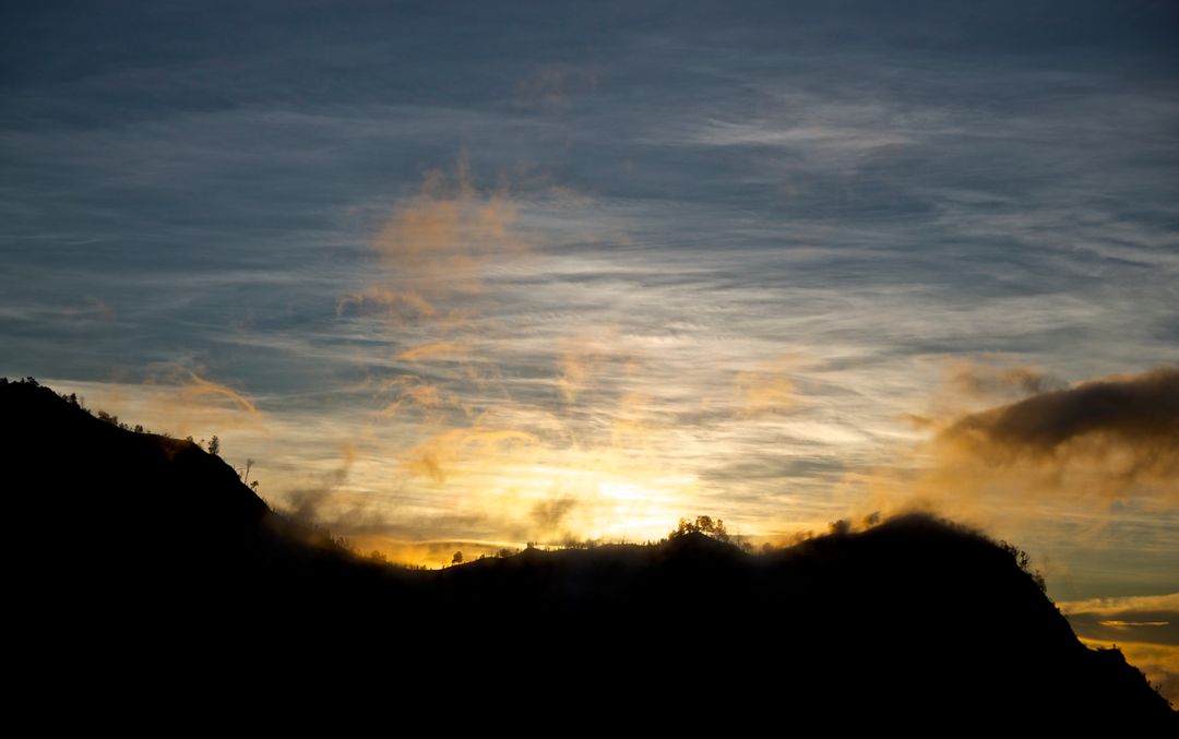 Sunrise Over Mountain Silhouette with Dramatic Sky - Free Images, Stock Photos and Pictures on Pikwizard.com