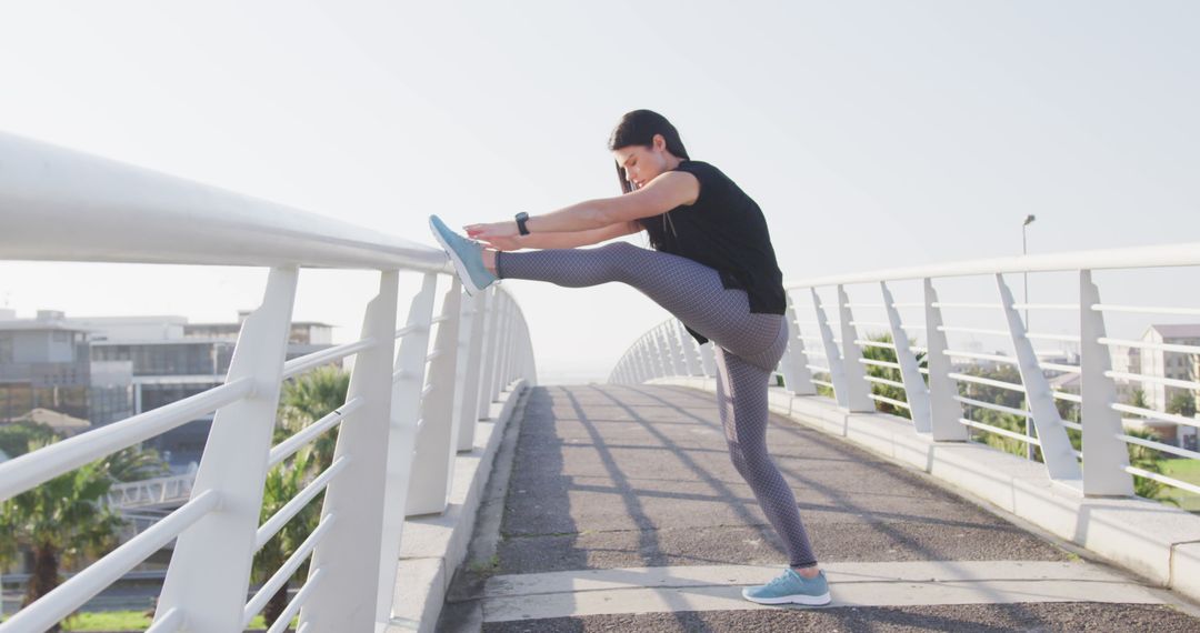 Woman Stretching on Bridge During Outdoor Workout - Free Images, Stock Photos and Pictures on Pikwizard.com