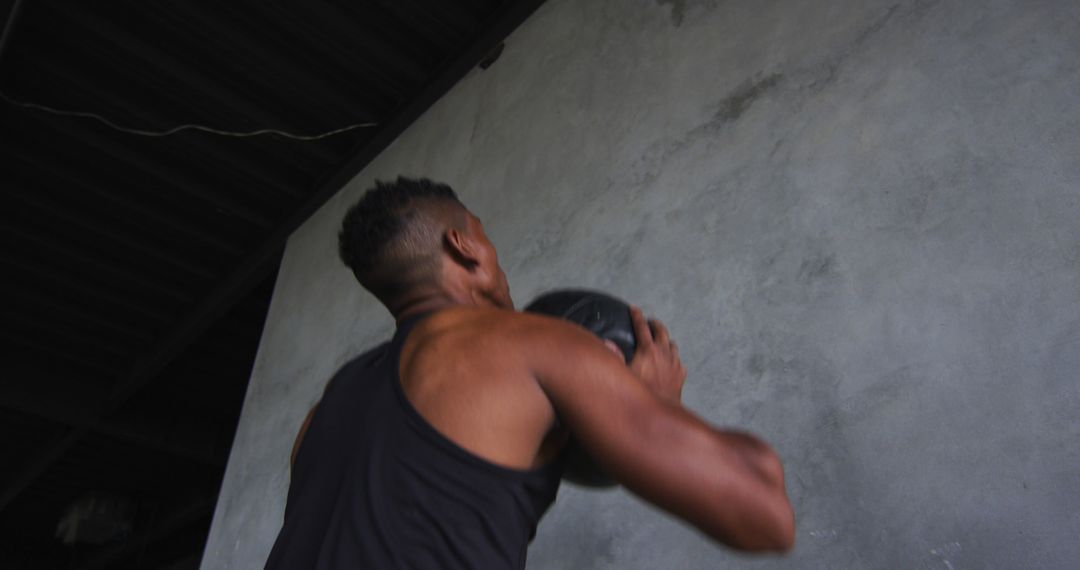 Athletic Man Training with Medicine Ball Against Concrete Wall - Free Images, Stock Photos and Pictures on Pikwizard.com