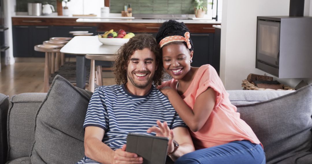 Diverse Couple Sharing Relaxing Digital Experience on Couch