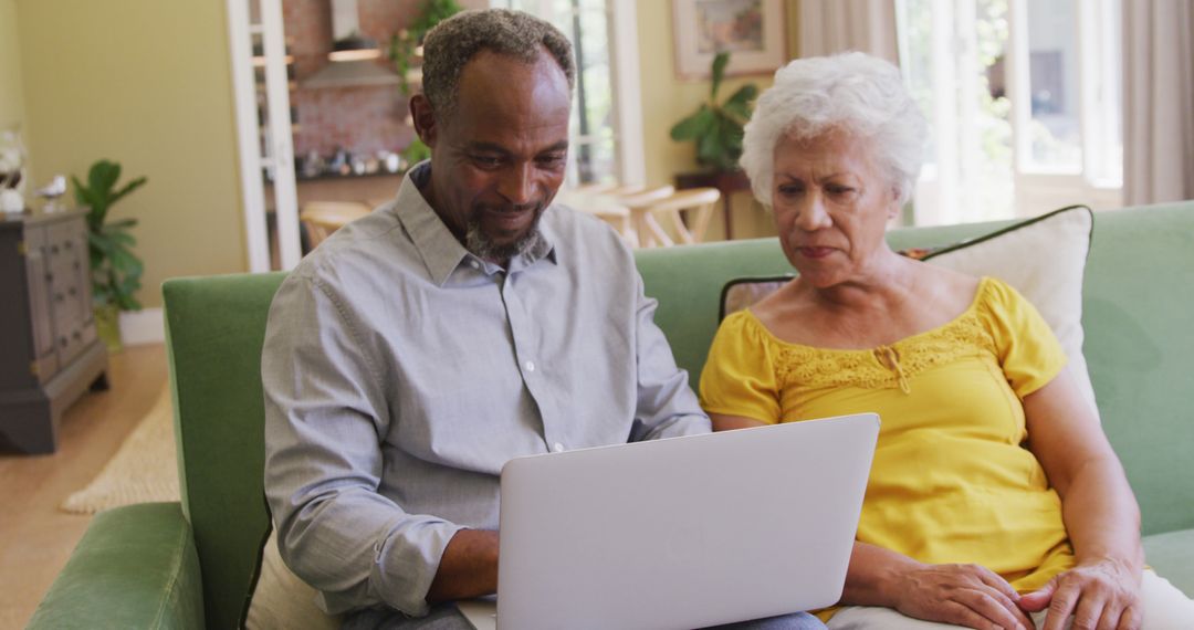 Senior Couple Enjoying Time Together with Laptop Technology