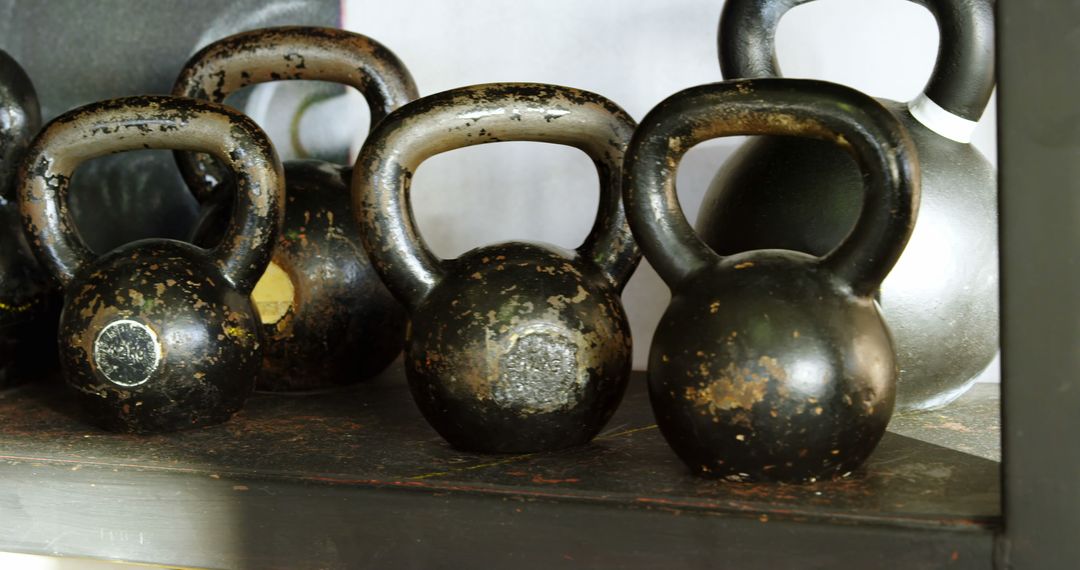 Old Kettlebells Sitting on Shelf in Rustic Gym - Free Images, Stock Photos and Pictures on Pikwizard.com