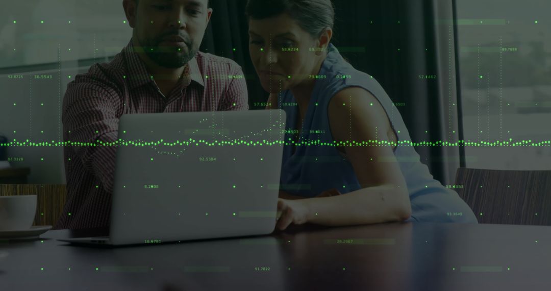 Diverse Colleagues Analyzing Financial Data on Laptop