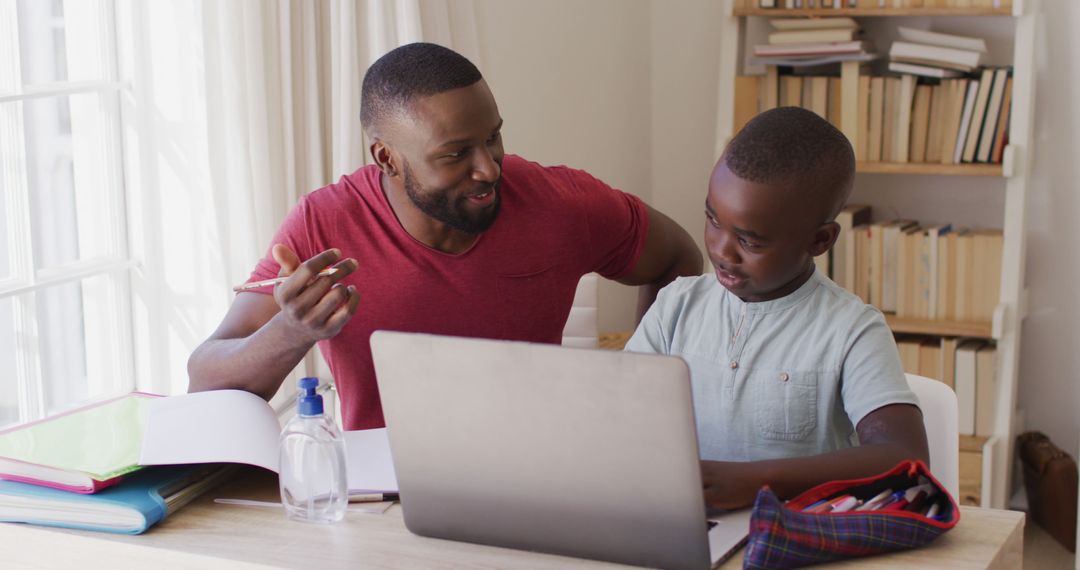 African American Father Helping Son with Homework on Laptop During COVID-19 Quarantine at Home - Free Images, Stock Photos and Pictures on Pikwizard.com