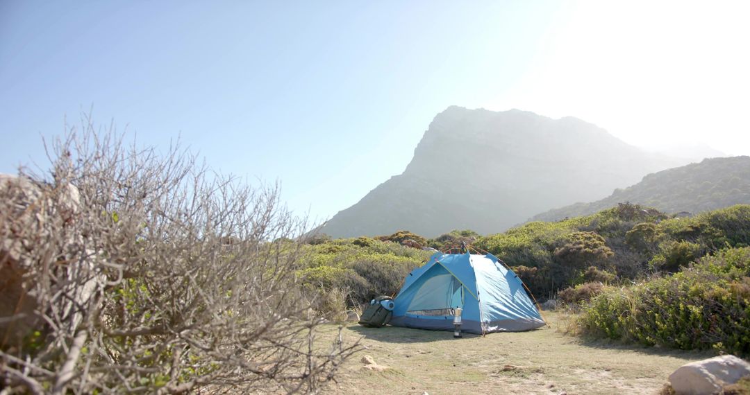 Blue Camping Tent in Open Field at Base of Majestic Mountain