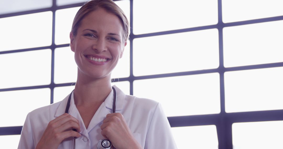 Smiling Female Doctor with Stethoscope in Hospital Setting - Free Images, Stock Photos and Pictures on Pikwizard.com