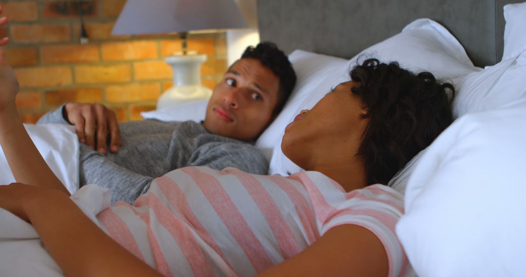 Couple Relaxing in Bed Having Intimate Conversation